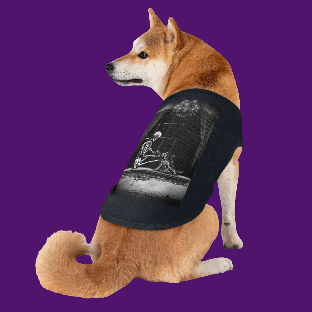 Dog wearing a black t-shirt with a graphic design on a purple background