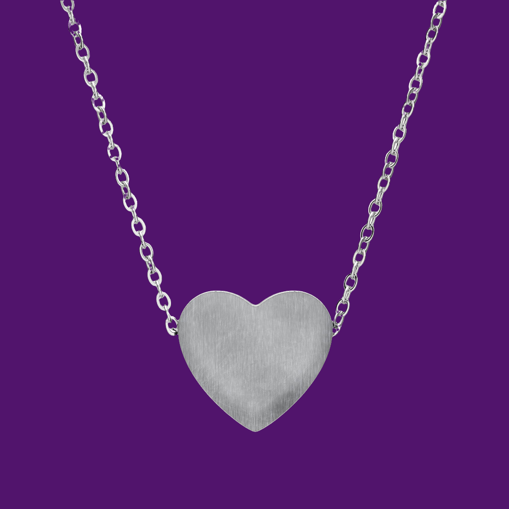 Silver heart-shaped pendant on a chain against a purple background