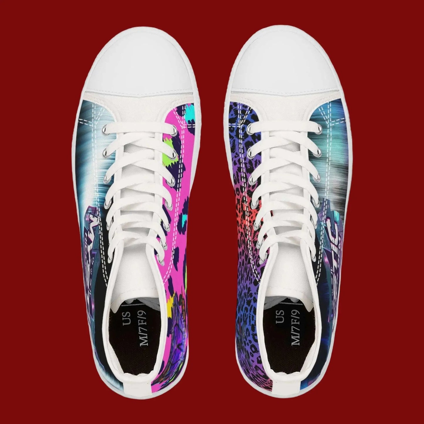 Pair of white sneakers with colorful designs on a red background